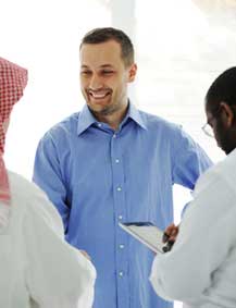 Business meeting between a Western engineer and his Arab colleagues